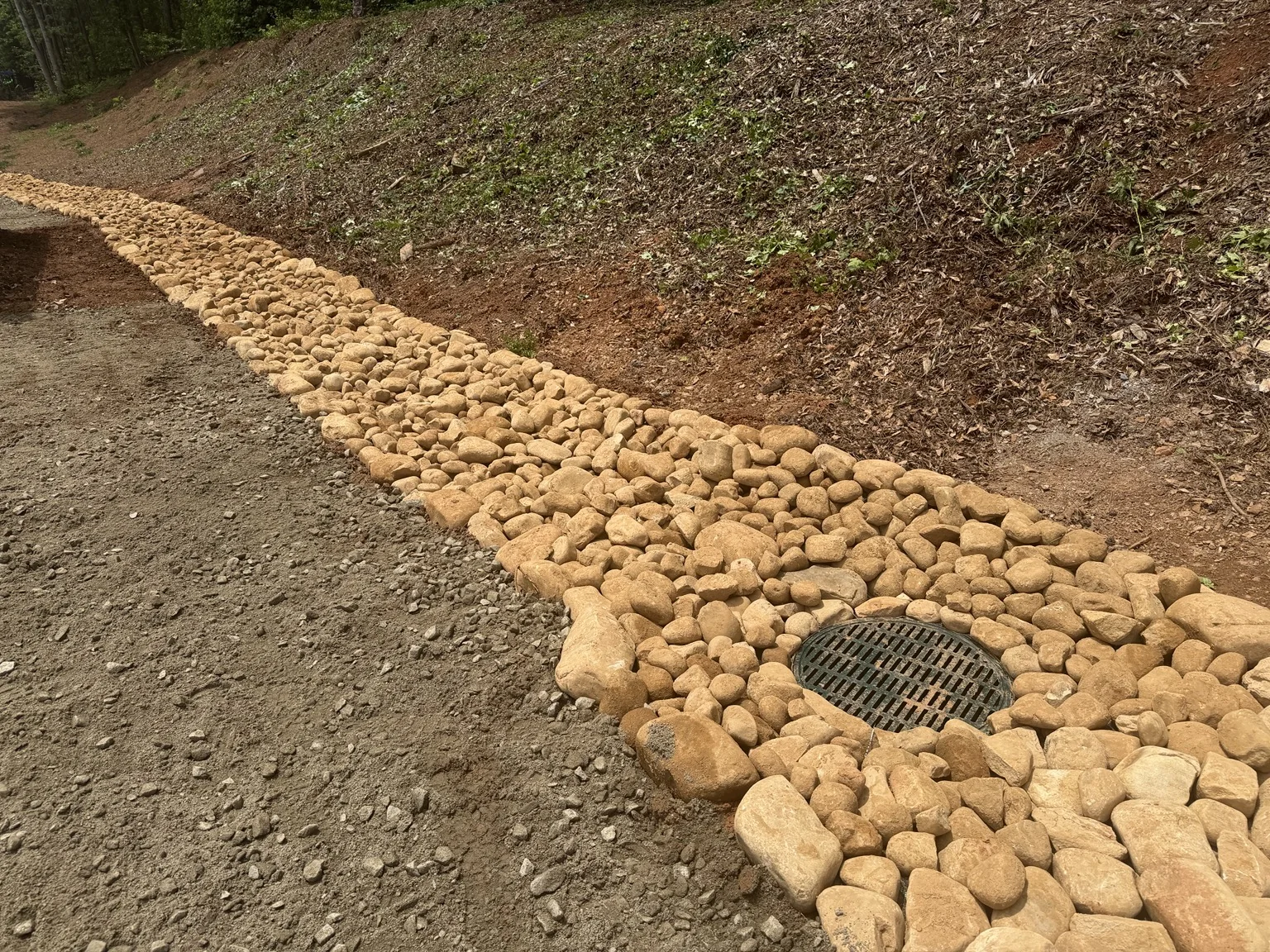 Drainage channel with stone and catch basin